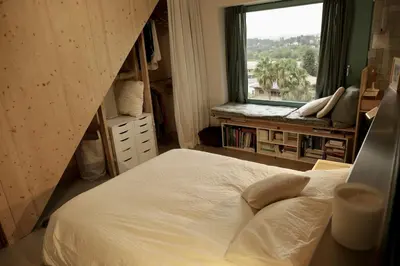 a bedroom with a large bed and a window at Independent duplex in a stately villa in Sant Cugat del Vallès