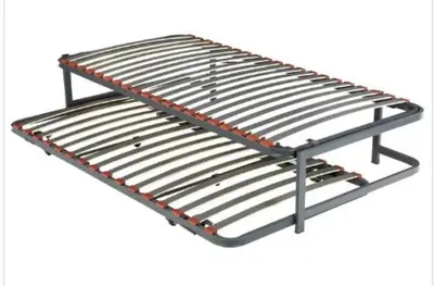 a metal bed frame with a metal rack at Quiet cozy apartment near beach in Sitges