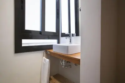 a bathroom with a sink and a mirror at Tendency Apartments - Sagrada Familia in Barcelona