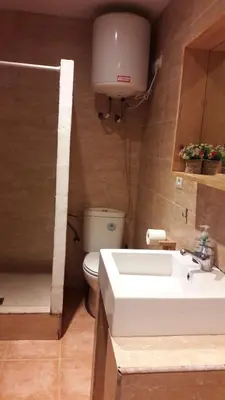 a bathroom with a white sink and a toilet at Fasten in Barcelona