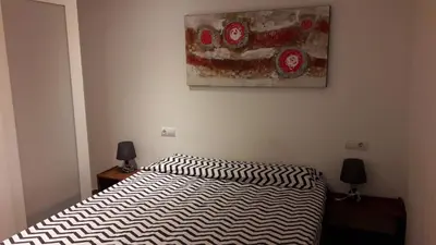 a bedroom with a bed and a painting on the wall at Fasten in Barcelona