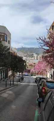 a city street with cars parked on the side of the road at Fasten in Barcelona