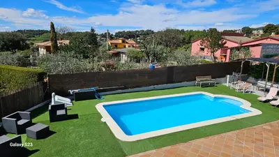 a large swimming pool in a yard with grass at Tranquilidad y Privacidad in Cánoves