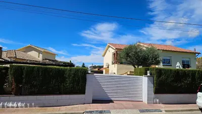 a white fence in front of a house at Tranquilidad y Privacidad in Cánoves