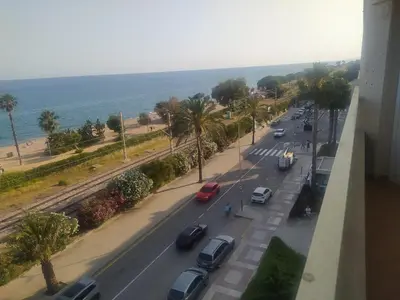 a view of a street with cars parked on the road at Precioso apartamento en primera linea de mar Beautiful apartment on the first line of the sea in Pineda de Mar