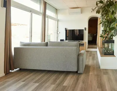 a living room with a couch and a television at Casa en Sierra Collserola in Sant Cugat del Vallès