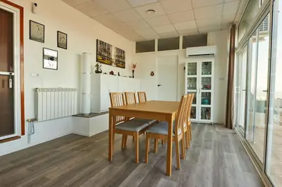 a dining room with a wooden table and chairs at Casa en Sierra Collserola in Sant Cugat del Vallès