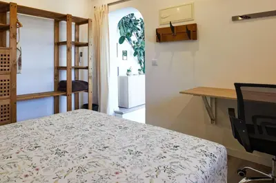 a room with a table and a kitchen with a refrigerator at Casa en Sierra Collserola in Sant Cugat del Vallès