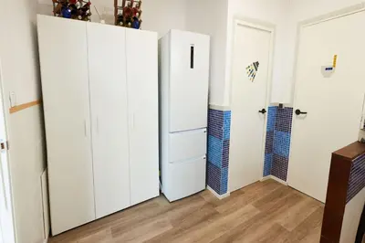 two white closets in a room with wooden floors at Casa en Sierra Collserola in Sant Cugat del Vallès