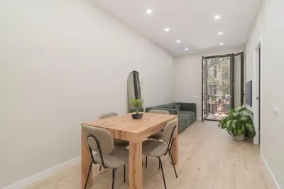 a dining room with a wooden table and chairs at GuestReady- Lovely apartment in Barcelona in Barcelona