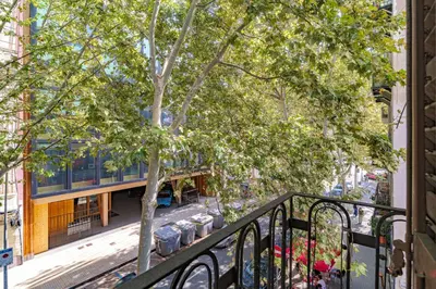 a balcony with a tree and a building at GuestReady- Lovely apartment in Barcelona in Barcelona
