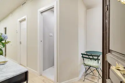 a bathroom with a walk in shower and a chair at GuestReady- Lovely apartment in Barcelona in Barcelona
