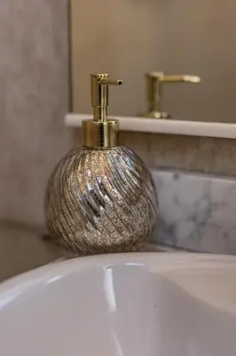 a bathroom sink with a gold faucet on top of it at Estudio con encanto en Barcelona in Barcelona