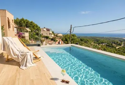 a living room with a couch and a table at Les Flors de Cunit Villa Liria in Cunit