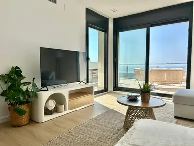 a balcony with a table and chairs and a view of the ocean at Les Flors de Cunit Villa Liria in Cunit