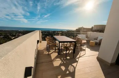 a dining room with a table and a view of the ocean at Les Flors de Cunit Villa Liria in Cunit