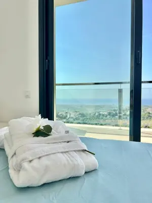 a bedroom with a bed and a mirror and a table at Les Flors de Cunit Villa Liria in Cunit