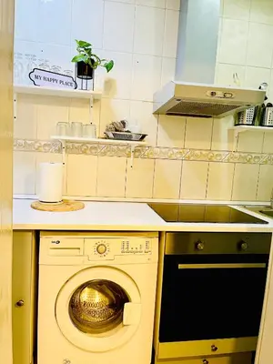 a kitchen with a washing machine in a kitchen at Basic interior Apartment Sagrada Familia Excellent for exploring Barcelona Very good location in Barcelona
