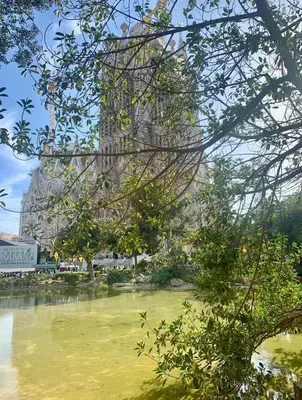 a view of a tall building in the background of a body of water at Basic interior Apartment Sagrada Familia Excellent for exploring Barcelona Very good location in Barcelona