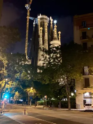 a tall building is lit up at night at Basic interior Apartment Sagrada Familia Excellent for exploring Barcelona Very good location in Barcelona