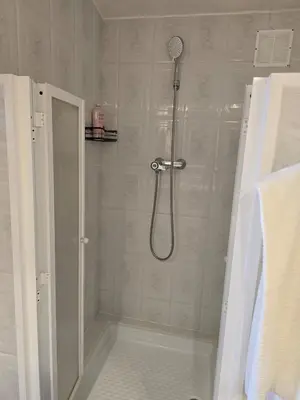 a shower with a shower head in a bathroom at Can Marisu, Casita privada in Cabrils