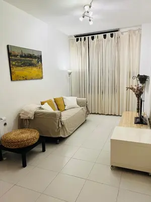 a living room with a couch and a table at Acojedor apartamento, centro con patio in Sabadell