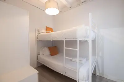 a small room with two bunk beds in it at Stay U-nique Roger Llúria in Barcelona