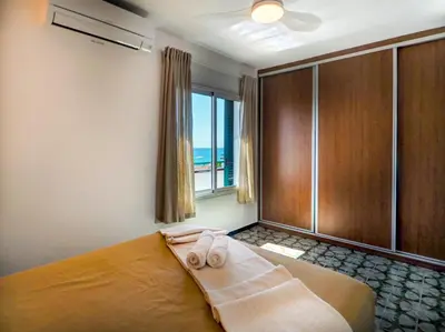 a bedroom with a bed with two towels on it at Horizon Views by Hello Homes Sitges in Sitges