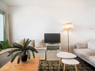 a living room with a couch and a tv at Horizon Views by Hello Homes Sitges in Sitges