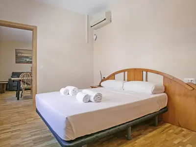 a bedroom with a bed with towels on it at Winahost Sabadell Buxeda in Sabadell