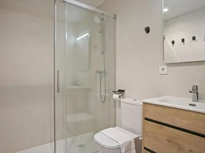 a bathroom with a shower and a toilet and a sink at Winahost Sabadell Buxeda in Sabadell