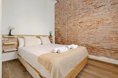 a living room with a table and chairs and a couch at Pet-Friendly Monthly 1BR in Central BCN in Barcelona