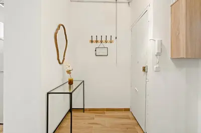 a hallway with white walls and a plant at Pet-Friendly Monthly 1BR in Central BCN in Barcelona