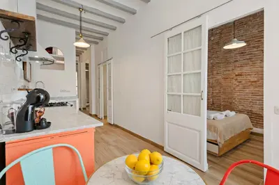 a living room with a glass table and chairs at Pet-Friendly Monthly 1BR in Central BCN in Barcelona