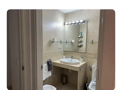 a bathroom with a sink and a toilet and a mirror at Lilli apartment in Sitges