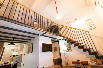 a living room with a staircase in a house at Cozy Equipped Duplex in Poblenou Ideal for 4 Guests and Close to Public Transport in Barcelona