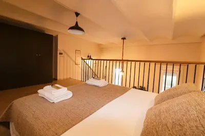 a bedroom with a bed with two towels on it at Cozy Equipped Duplex in Poblenou Ideal for 4 Guests and Close to Public Transport in Barcelona