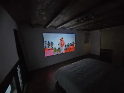 a bedroom with a tv on the wall at Industrial loft in Eixample near Sagrada familia in Barcelona