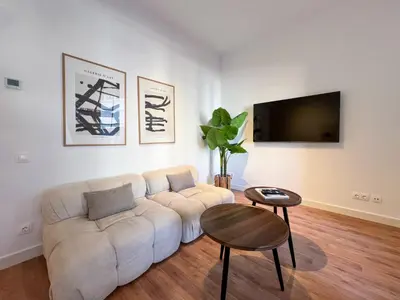 a living room with a white couch and a table at Stay U-nique Apartments Balmes III in Barcelona