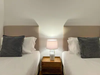 a bedroom with two beds and a lamp on a night stand at Stay U-nique Apartments Balmes III in Barcelona