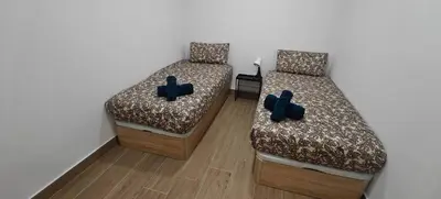 two beds with blue pillows in a room at Exquisite Flat in Martorell (Barcelona) in Martorell
