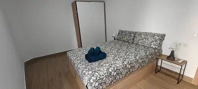 a bedroom with a bed with a blue hat on it at Exquisite Flat in Martorell (Barcelona) in Martorell