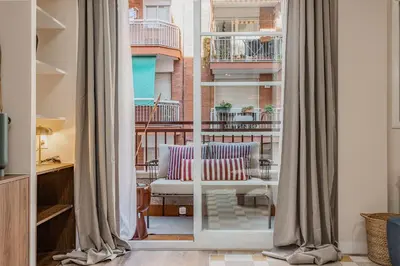 a living room with a couch and a window at Comfortable and spacious flat in Barcelona in Barcelona