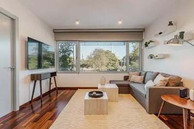 a living room with a couch and a table at Beachside apartment in Barcelona