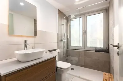 a white bathroom with a sink and a toilet at Beachside apartment in Barcelona