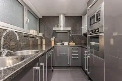a kitchen with stainless steel cabinets and a sink at Beachside apartment in Barcelona