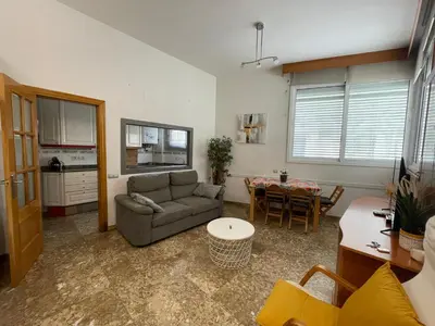 a living room with a couch and a table at Casa la Luna in Badalona
