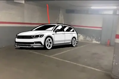 a white car parked in a parking garage at Casa la Luna in Badalona