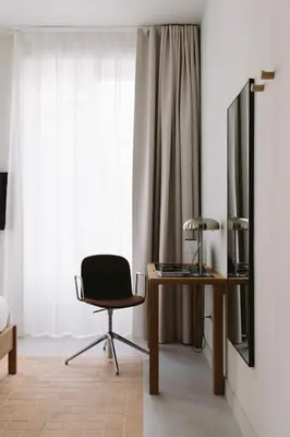 a desk with a laptop computer and a mirror at Outsite Barcelona in Barcelona