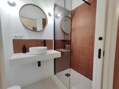 a bathroom with a sink and a mirror at Mazi Plaça Gran in Mataró